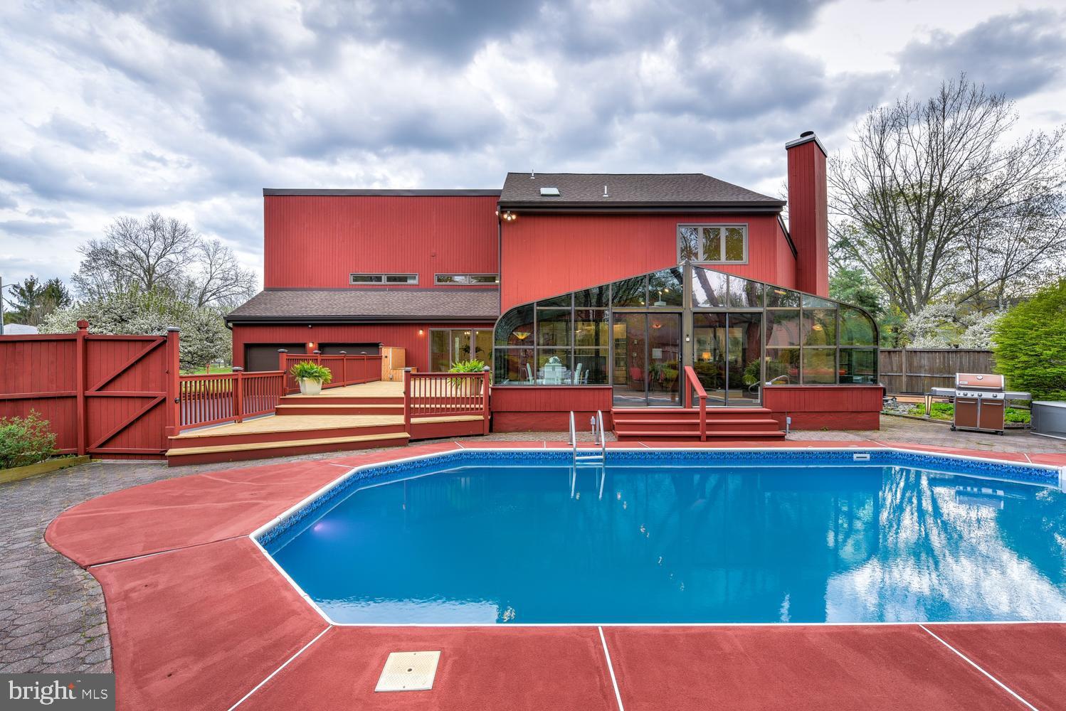 15 Hawk Drive Princeton Junction, NJ 08550 - Photo 74 of 95 a view of swimming pool with a table and chairs under an umbrella