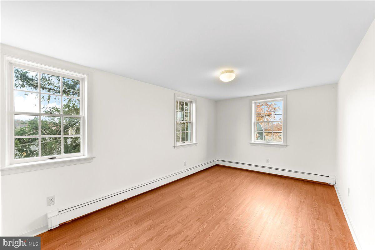 355 Gum Tree Road Coatesville, PA 19320 - Photo 12 of 24 an empty room with wooden floor and windows