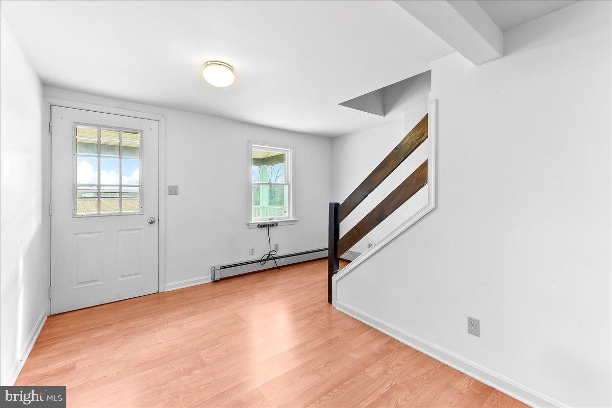 355 Gum Tree Road Coatesville, PA 19320 - Photo 5 of 24 a view of an empty room with wooden floor and stairs