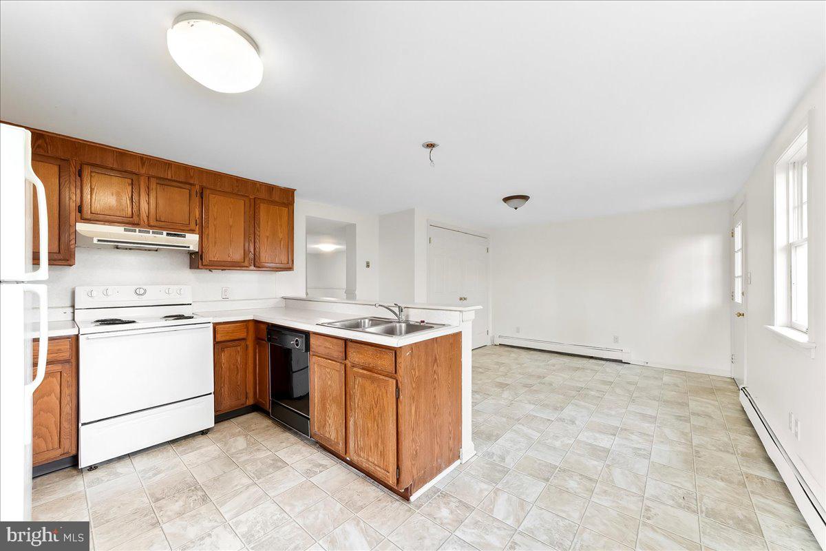 355 Gum Tree Road Coatesville, PA 19320 - Photo 9 of 24 a kitchen with a stove top oven sink and cabinets