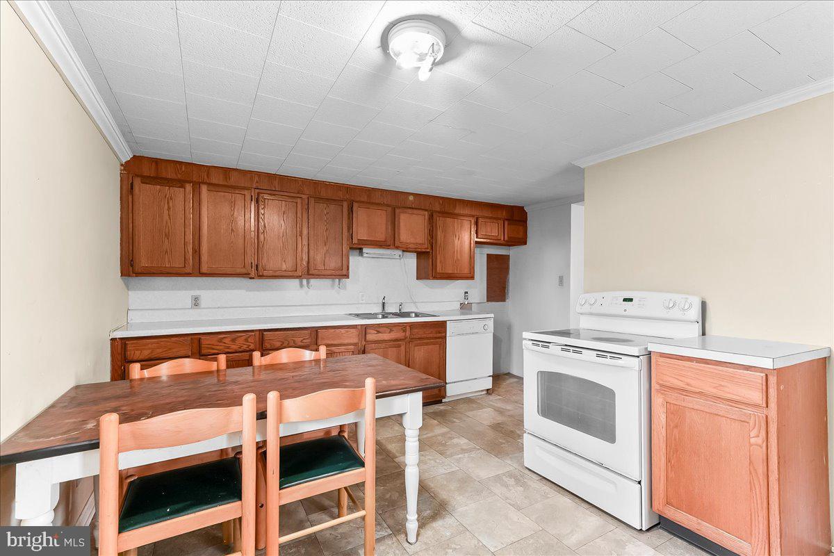 355 Gum Tree Road Coatesville, PA 19320 - Photo 10 of 24 a kitchen with granite countertop wooden cabinets and white appliances