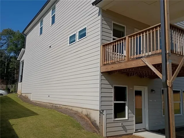 a view of a house with backyard and deck