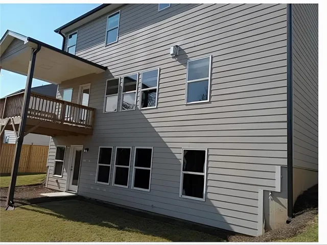 a view of a house with wooden deck