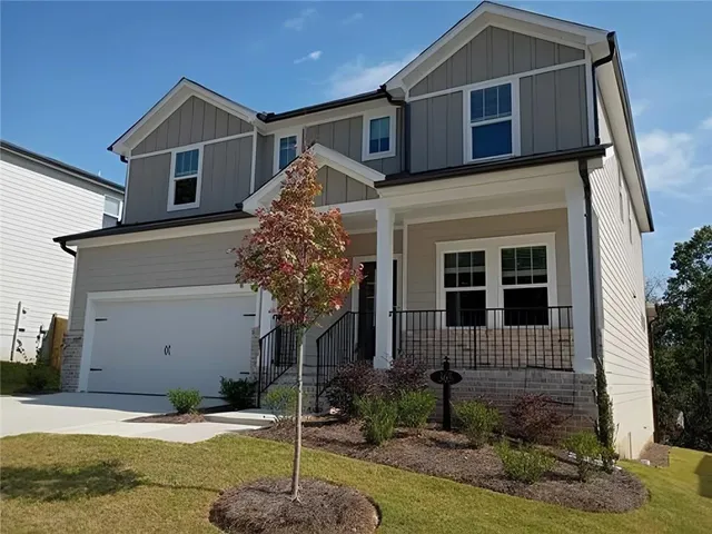 a front view of a house with garden