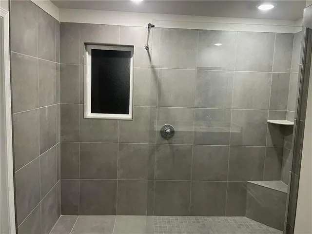 a bathroom with a shower and a sink