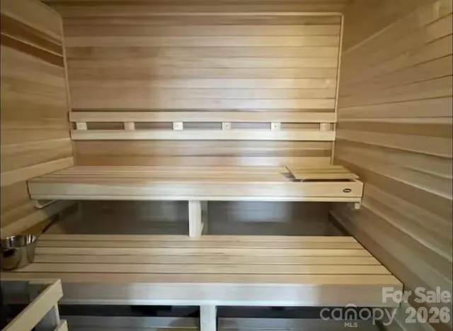 a room with lots of white furniture and a window