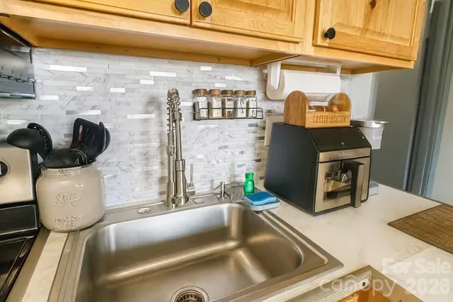 a kitchen with a sink and a refrigerator