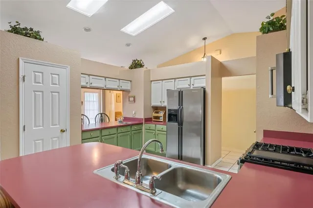 a kitchen with stainless steel appliances granite countertop a refrigerator and a sink