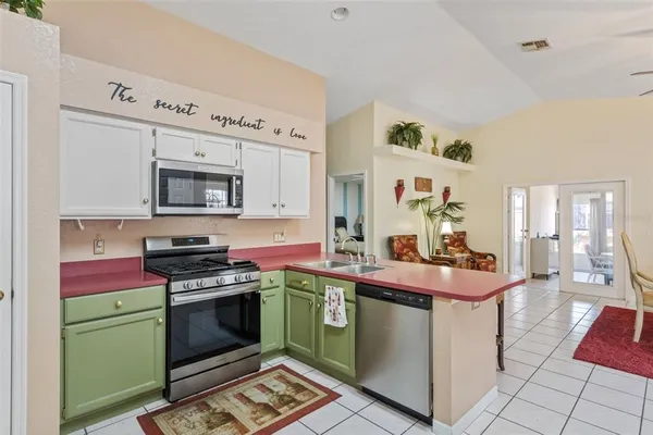 a kitchen with a sink stove and cabinets