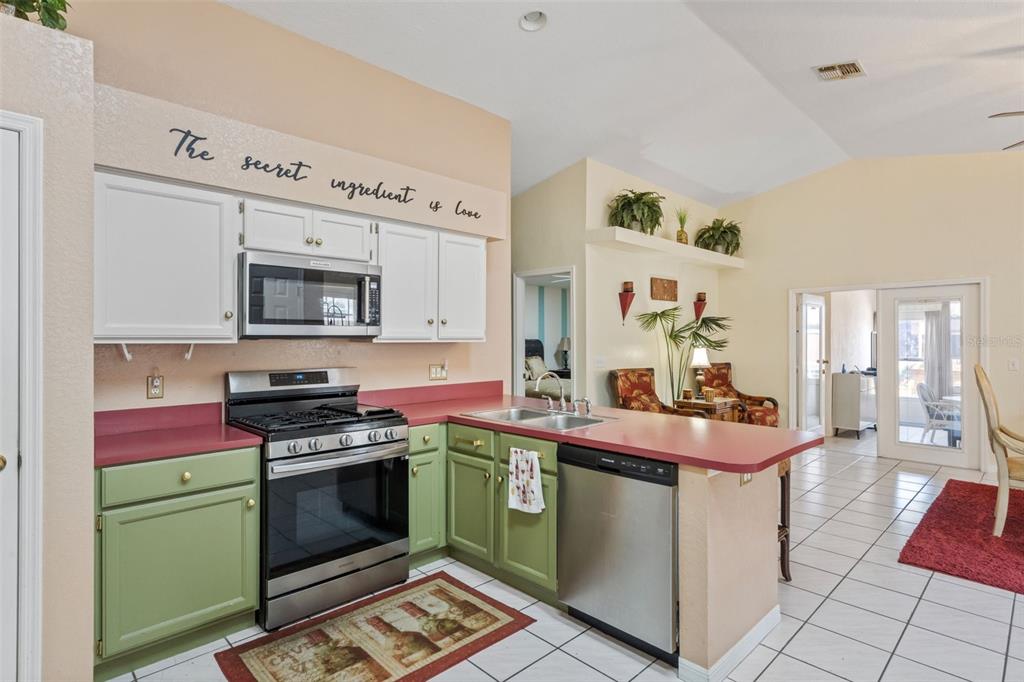 511 Marcia Loop Winter Haven, FL 33884 - Photo 15 of 46 a kitchen with a sink stove and cabinets