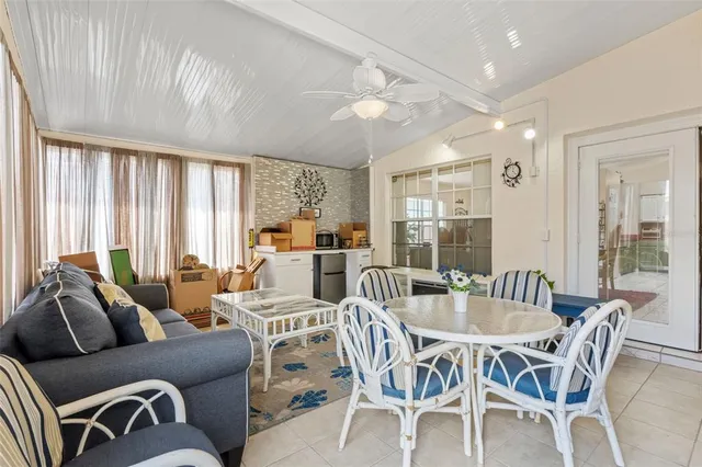 a dining room with furniture a chandelier and wooden floor