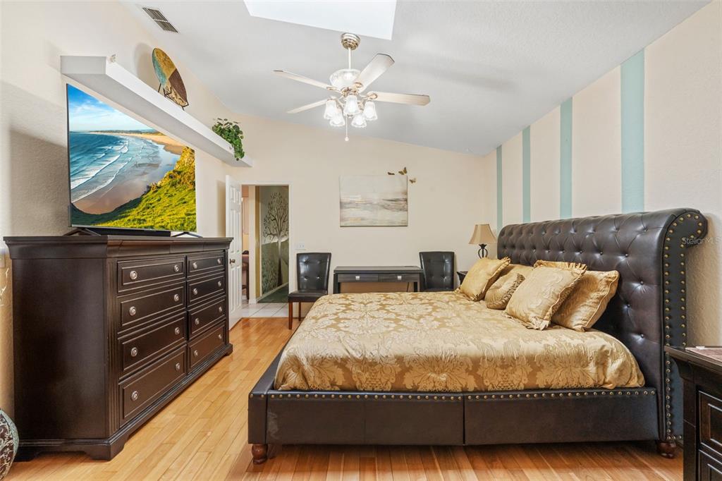 511 Marcia Loop Winter Haven, FL 33884 - Photo 19 of 46 a bedroom with a bed and a flat screen television