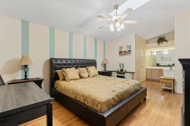 a bedroom with a large bed and a chandelier