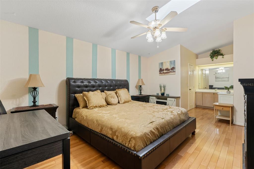 511 Marcia Loop Winter Haven, FL 33884 - Photo 20 of 46 a bedroom with a large bed and a chandelier