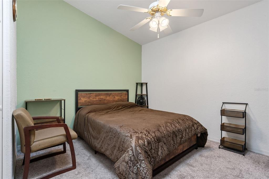 511 Marcia Loop Winter Haven, FL 33884 - Photo 24 of 46 a bedroom with a bed and a chandelier