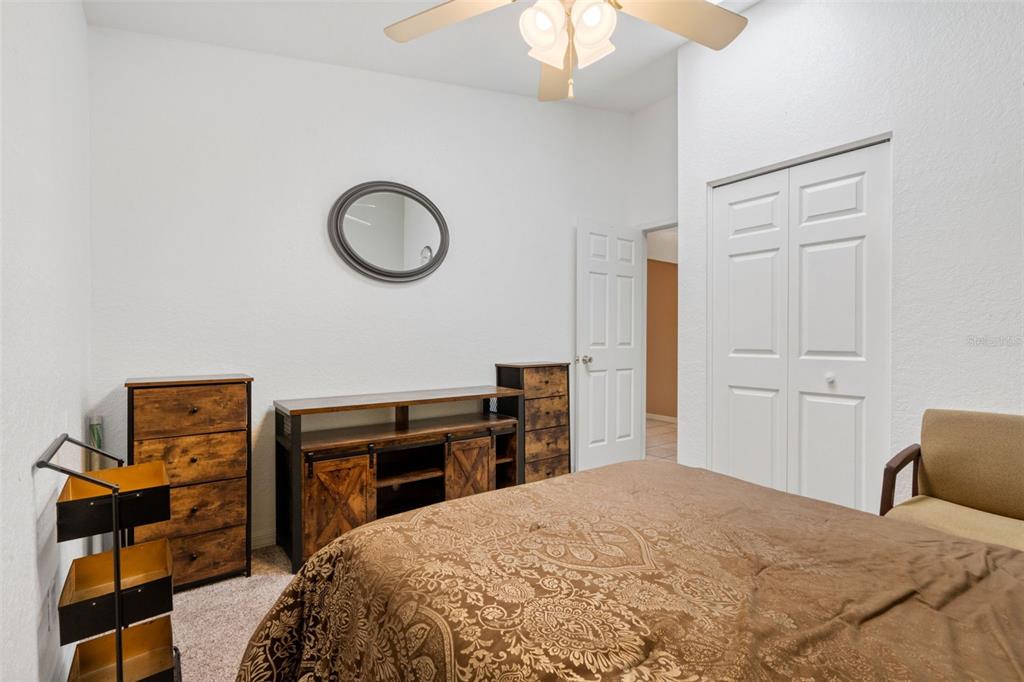 511 Marcia Loop Winter Haven, FL 33884 - Photo 25 of 46 a bedroom with a bed and a chandelier