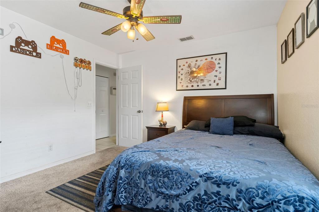 511 Marcia Loop Winter Haven, FL 33884 - Photo 27 of 46 a bedroom with a bed and a chandelier