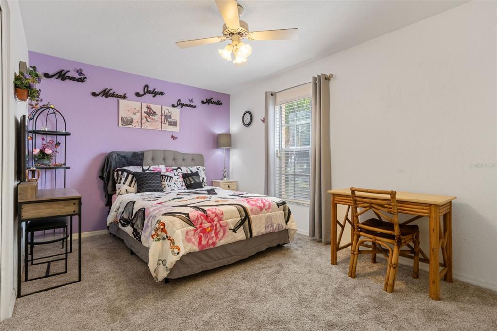 511 Marcia Loop Winter Haven, FL 33884 - Photo 30 of 46 a bedroom with a bed and a chandelier