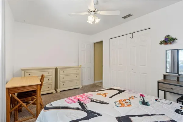 a bedroom with a bed and a dresser in it