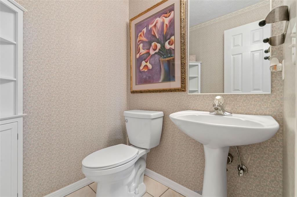 511 Marcia Loop Winter Haven, FL 33884 - Photo 32 of 46 a bathroom with a toilet sink and mirror
