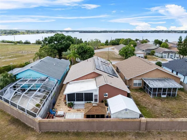 an aerial view of multiple houses with a yard
