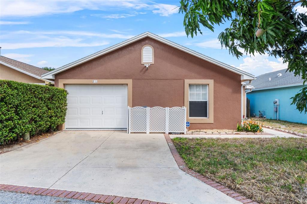 511 Marcia Loop Winter Haven, FL 33884 - Photo 39 of 46 a front view of a house with garden