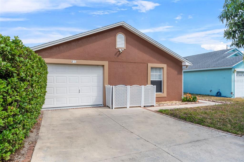 511 Marcia Loop Winter Haven, FL 33884 - Photo 40 of 46 a front view of a house with a yard and garage