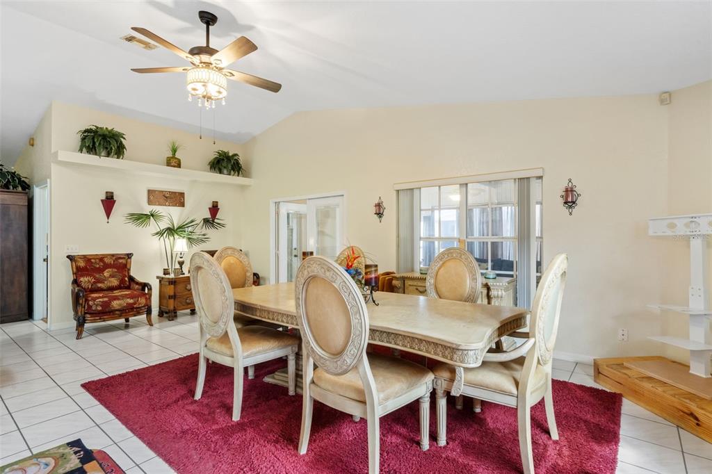 511 Marcia Loop Winter Haven, FL 33884 - Photo 10 of 46 a dining room with furniture a rug and a chandelier