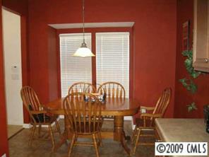 114 Snead Road, Unit 114 Fort Mill, SC 29715 - Photo 4 of 7 a view of a dining room with furniture and wooden floor