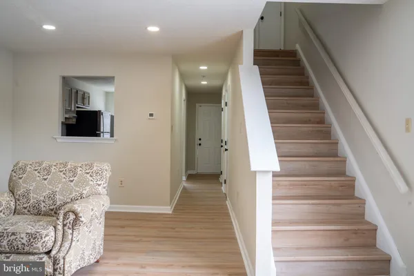 a view of entryway and hall with wooden floor