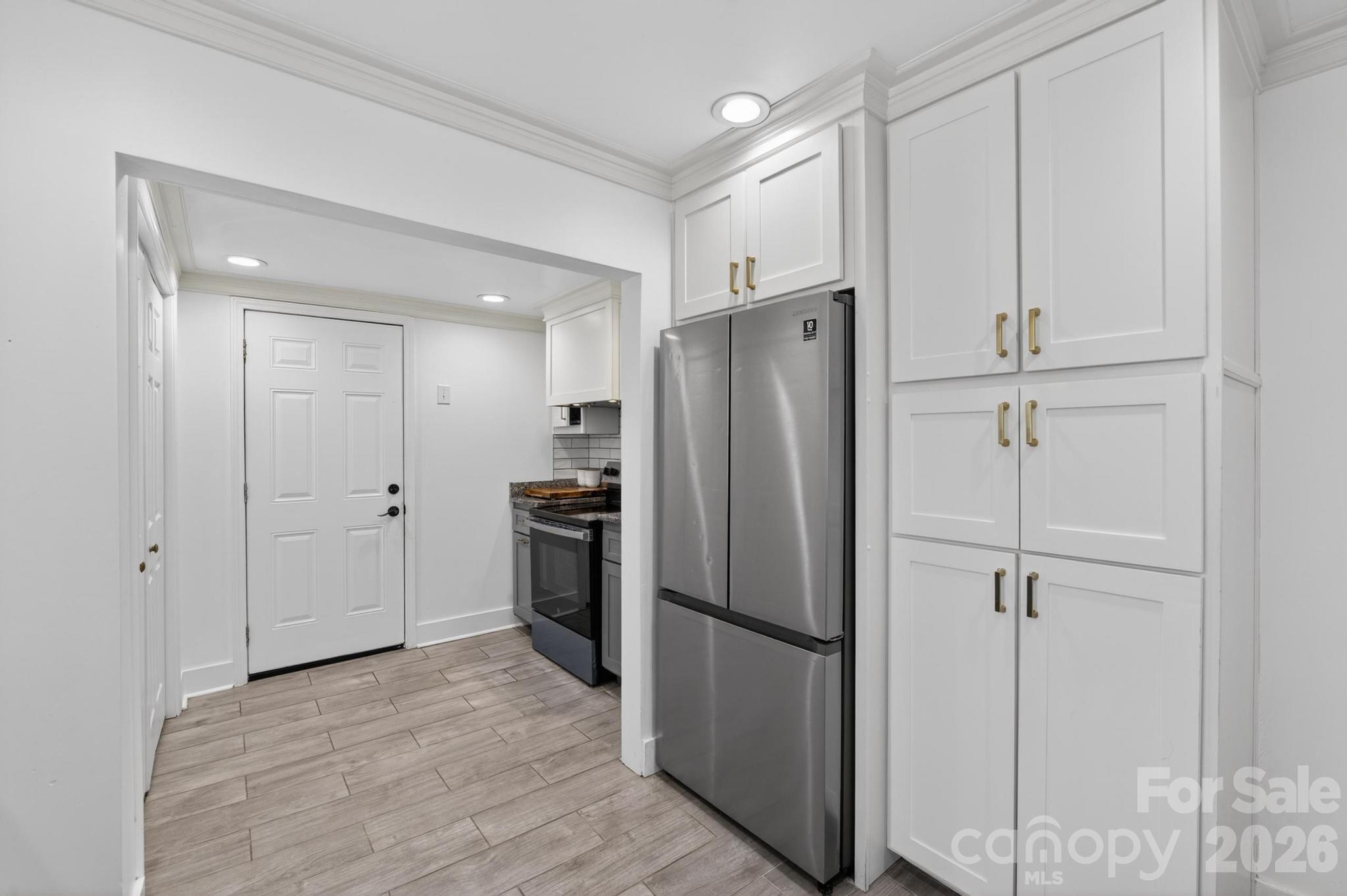 2076 Connelly Springs Road Lenoir, NC 28645 - Photo 19 of 47 a kitchen with stainless steel appliances a refrigerator and cabinets