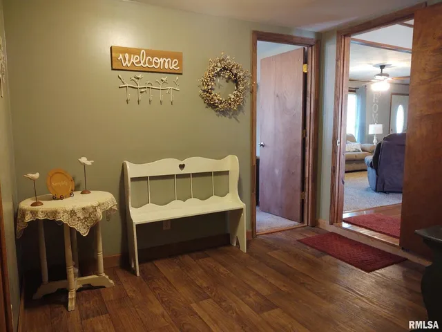 a view of hall way with mirror and stairs