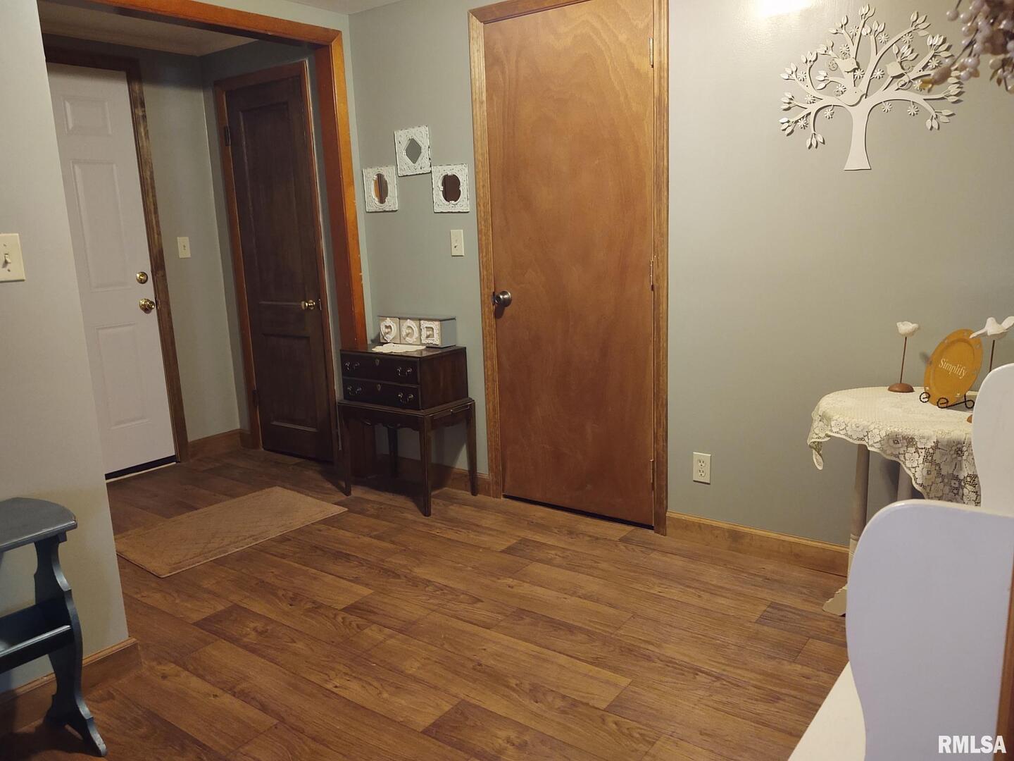901 Locust Street Vienna, IL 62995 - Photo 18 of 25 a bedroom with a bed and wooden floor