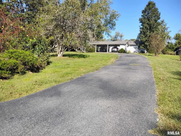 a view of house with outdoor space and parking