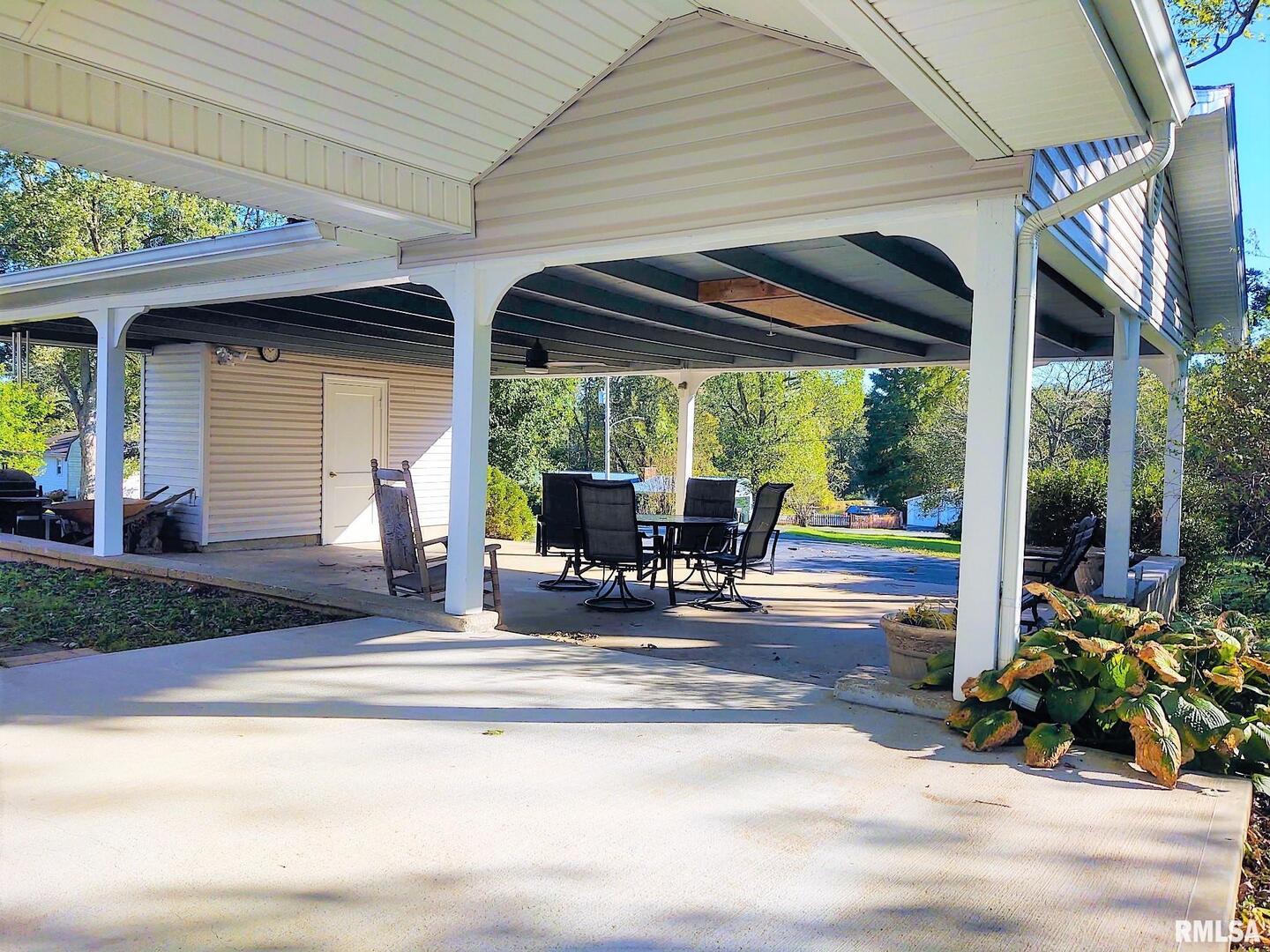 901 Locust Street Vienna, IL 62995 - Photo 9 of 25 a view of a porch with chairs and backyard