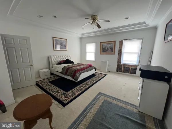 a living room with a bed furniture and a window