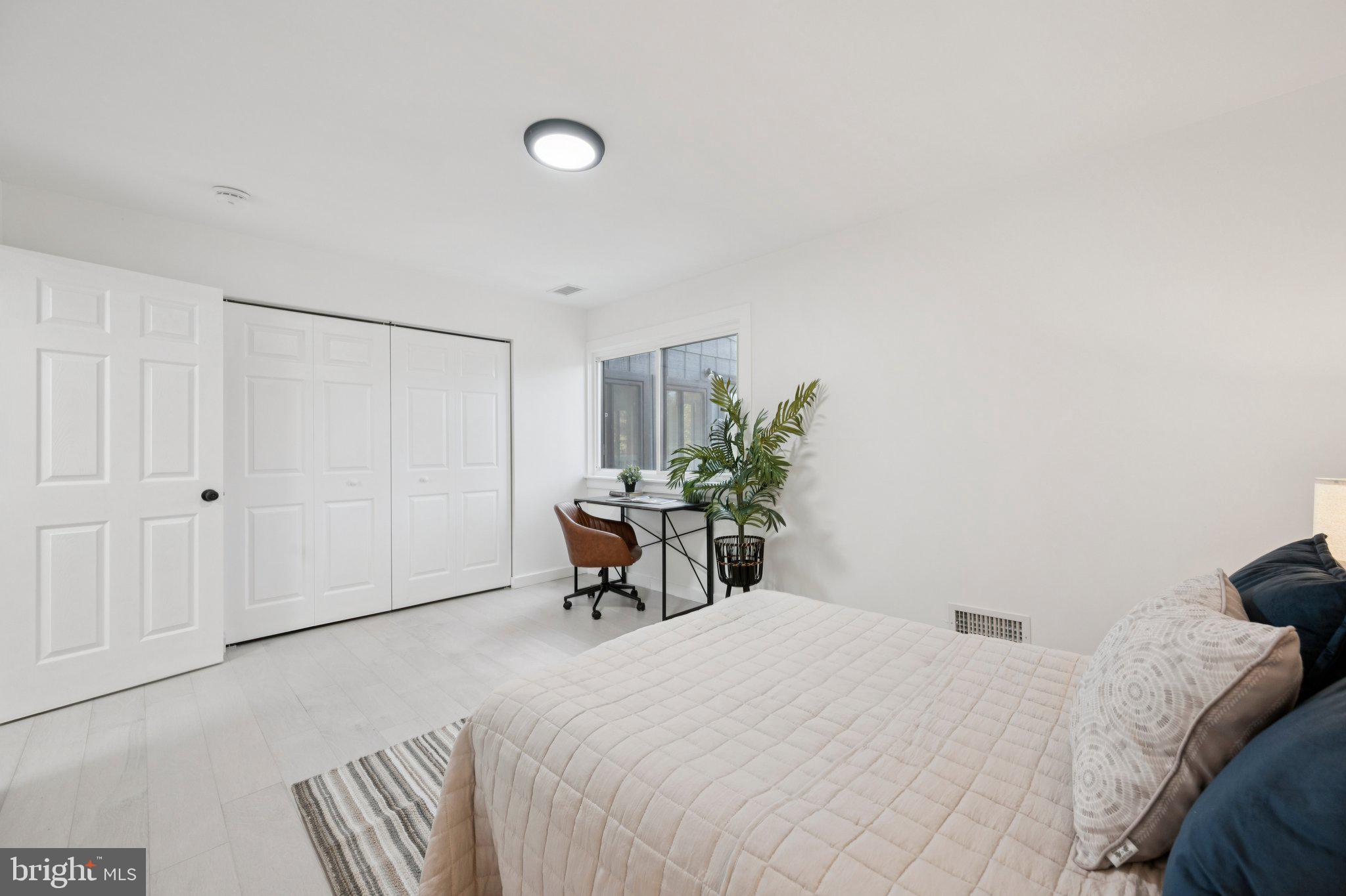 14912 Coles Chance Road North Potomac, MD 20878 - Photo 18 of 36 a bedroom with a bed and a potted plant