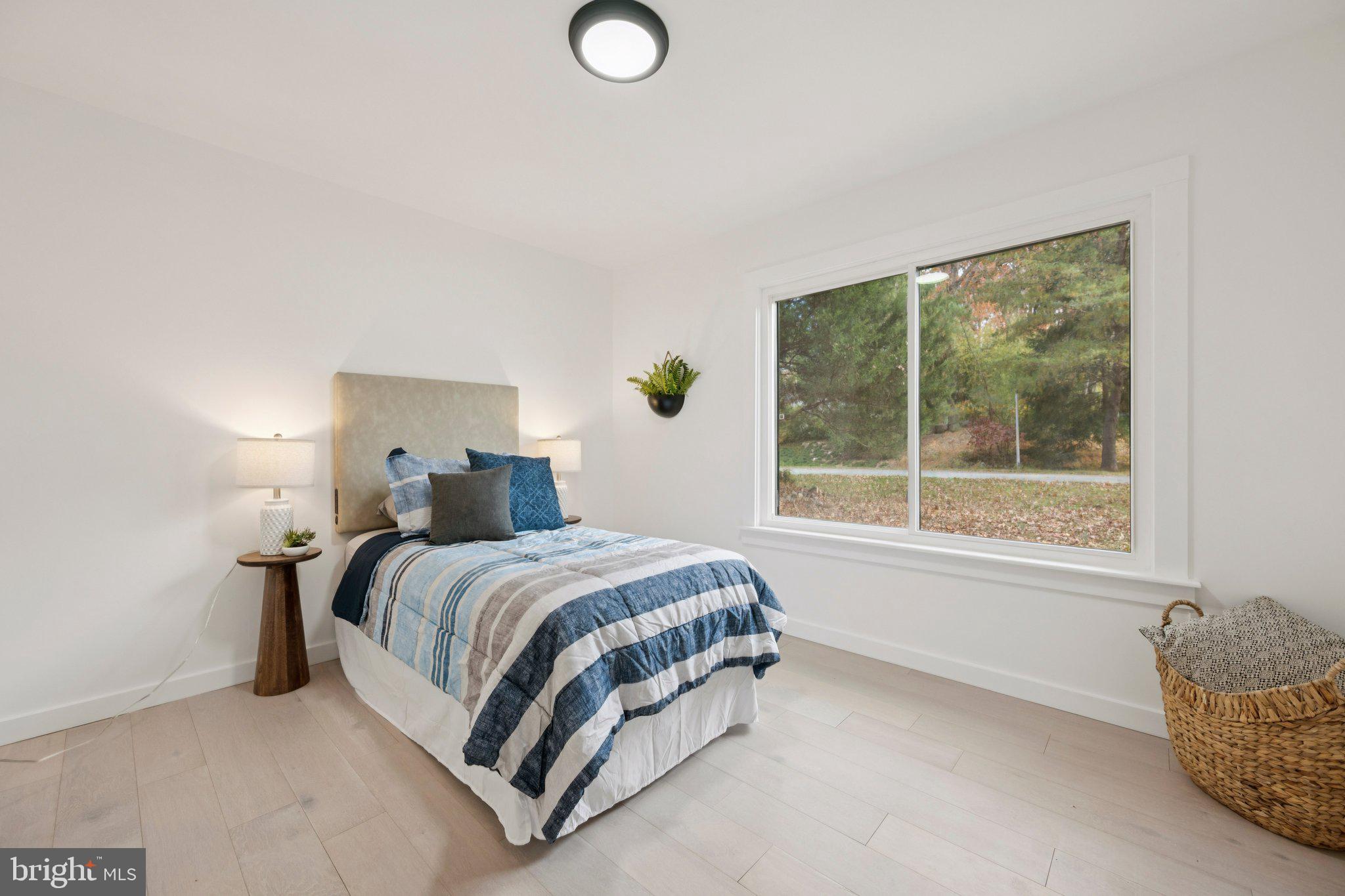 14912 Coles Chance Road North Potomac, MD 20878 - Photo 19 of 36 a bed sitting in a bedroom next to a window