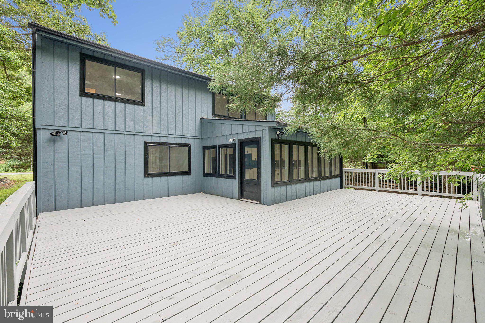 14912 Coles Chance Road North Potomac, MD 20878 - Photo 23 of 36 a view of backyard with deck and wooden floor