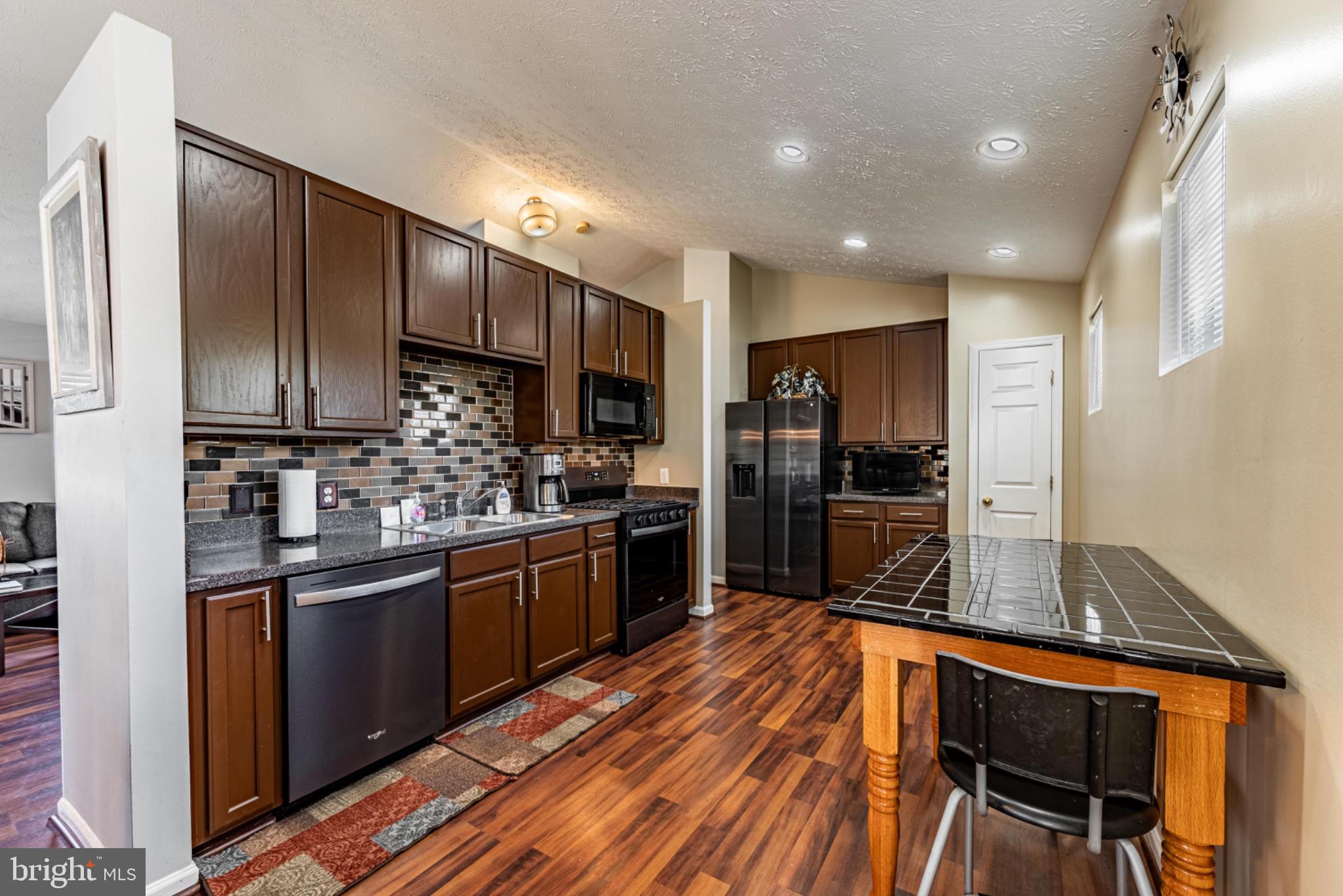 60 6 Point Court Baltimore, MD 21244 - Photo 12 of 28 a kitchen with stainless steel appliances wooden cabinets a refrigerator a stove a sink and dishwasher