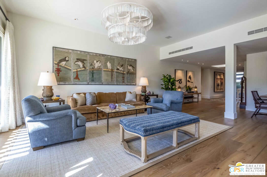 8 Surrey Court Rancho Mirage, CA 92270 - Photo 12 of 48 a living room with furniture and a chandelier