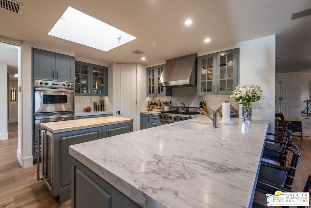 8 Surrey Court Rancho Mirage, CA 92270 - Photo 16 of 48 a kitchen with stainless steel appliances granite countertop a sink stove and refrigerator