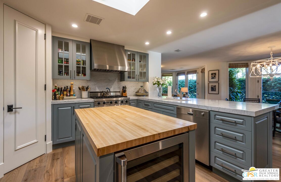 8 Surrey Court Rancho Mirage, CA 92270 - Photo 17 of 48 a kitchen with kitchen island a sink table and chairs