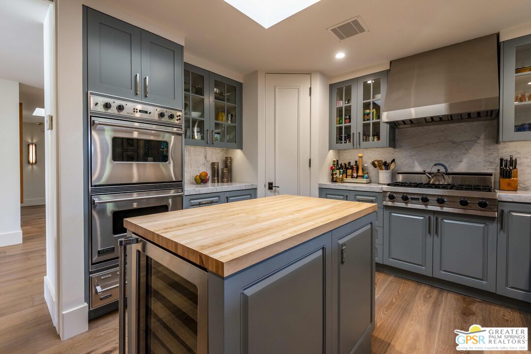 8 Surrey Court Rancho Mirage, CA 92270 - Photo 18 of 48 a kitchen with stainless steel appliances a stove a sink and a refrigerator