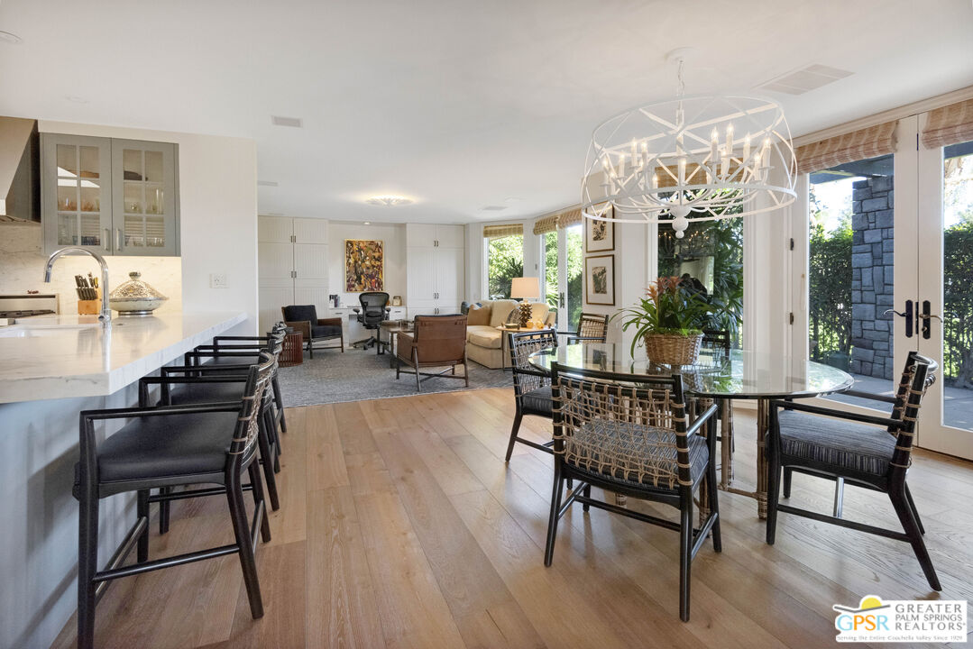 8 Surrey Court Rancho Mirage, CA 92270 - Photo 20 of 48 a living room with furniture and a chandelier
