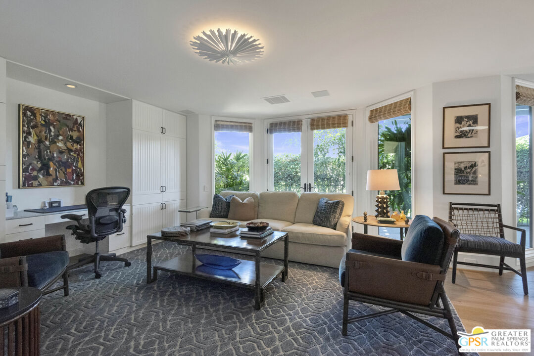 8 Surrey Court Rancho Mirage, CA 92270 - Photo 22 of 48 a living room with furniture a table and a large window
