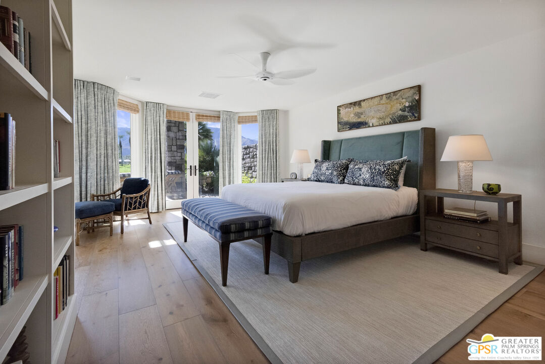 8 Surrey Court Rancho Mirage, CA 92270 - Photo 26 of 48 a bedroom with a bed and large windows