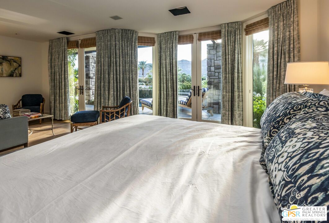 8 Surrey Court Rancho Mirage, CA 92270 - Photo 28 of 48 a bed sitting in a spacious bedroom next to a window