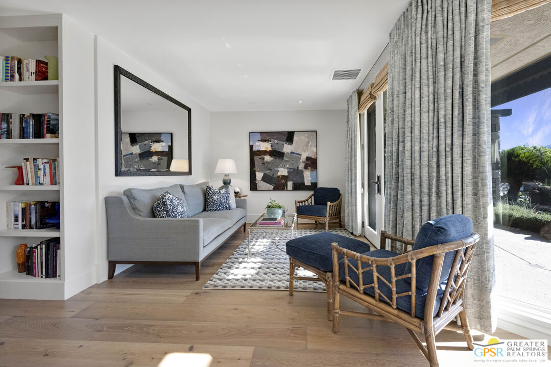 8 Surrey Court Rancho Mirage, CA 92270 - Photo 29 of 48 a living room with furniture and a book shelf