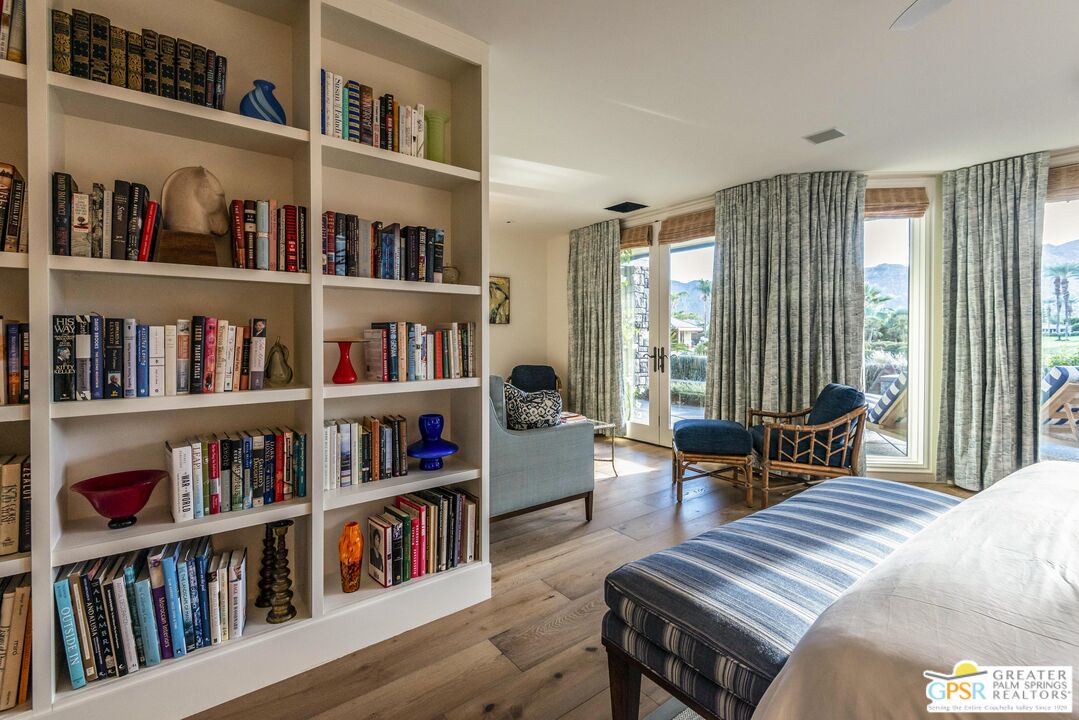 8 Surrey Court Rancho Mirage, CA 92270 - Photo 30 of 48 a bedroom with furniture and a book shelf